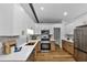 Bright, modern kitchen with two-tone cabinets, quartz countertops, and stainless steel appliances at 3021 Stone Bridge Sw Trl, Conyers, GA 30094