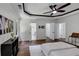 Bright primary bedroom with a tray ceiling, wood flooring, and modern decor at 3021 Stone Bridge Sw Trl, Conyers, GA 30094