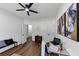 Modern office space with hardwood floors, computer desk, accent wall decorations, and ceiling fan at 3021 Stone Bridge Sw Trl, Conyers, GA 30094