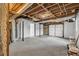 Unfinished basement with exposed ceiling, concrete floor and garage door at 6607 Forestdale Ln, Douglasville, GA 30135