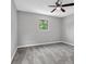 Standard bedroom with grey walls, neutral carpeting, window and ceiling fan at 6607 Forestdale Ln, Douglasville, GA 30135