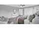 The bedroom is painted with light grey paint, a round mirror, and a luxurious comfortable bed at 6607 Forestdale Ln, Douglasville, GA 30135
