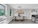Elegant dining room with modern lighting, seating for six, and decorative accents at 6607 Forestdale Ln, Douglasville, GA 30135