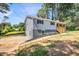 Beautiful home with gray siding, black shutters, and a side entrance garage at 6607 Forestdale Ln, Douglasville, GA 30135