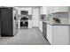 Modern kitchen featuring stainless steel appliances, white cabinets, and a sleek backsplash at 6607 Forestdale Ln, Douglasville, GA 30135