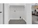 The open laundry area has updated tile floors with white folding doors and dining room view at 6607 Forestdale Ln, Douglasville, GA 30135