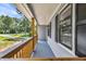 Relaxing covered porch featuring wood railings and posts perfect for enjoying the outdoors at 6607 Forestdale Ln, Douglasville, GA 30135
