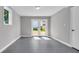 Sun-filled room with gray tile flooring, window, and double French doors at 6607 Forestdale Ln, Douglasville, GA 30135