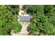 Aerial view of the property with mature trees, a wooden deck, and a charming single-story home at 2546 N Crestview Dr, Grayson, GA 30017