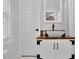 Bathroom featuring a vessel sink, wood countertop, white cabinets, and updated fixtures at 2546 N Crestview Dr, Grayson, GA 30017