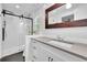 Bright bathroom featuring a glass-enclosed shower, gray countertop, white cabinets, and updated fixtures at 2546 N Crestview Dr, Grayson, GA 30017