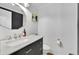 Bathroom featuring a white marble countertop, dark cabinets, and updated fixtures at 2546 N Crestview Dr, Grayson, GA 30017