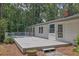 Spacious wooden deck with white railings, accessible through French doors, perfect for outdoor relaxation at 2546 N Crestview Dr, Grayson, GA 30017