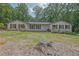 Single-story home with brick accents, wood shutters, and a well-manicured front yard and mature trees at 2546 N Crestview Dr, Grayson, GA 30017
