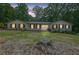 Inviting home exterior featuring a well-lit entry, complemented by a lush lawn and surrounding trees at 2546 N Crestview Dr, Grayson, GA 30017