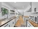 Stylish kitchen with white cabinets, butcher block counters, stainless appliances and herringbone backsplash at 2546 N Crestview Dr, Grayson, GA 30017