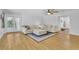 Spacious living room with hardwood floors, ample seating, and view to outside French doors at 2546 N Crestview Dr, Grayson, GA 30017