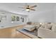 Living room with hardwood floors, ample seating, and natural light from the surrounding windows at 2546 N Crestview Dr, Grayson, GA 30017