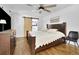 Comfortable bedroom featuring a wooden bed frame, a ceiling fan, hardwood floors, and a sliding barn door at 2546 N Crestview Dr, Grayson, GA 30017