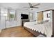 Comfortable bedroom featuring a wooden bed frame, a ceiling fan, hardwood floors, and natural lighting at 2546 N Crestview Dr, Grayson, GA 30017