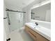 Modern bathroom with a glass-enclosed shower, floating vanity, and sleek fixtures, offering a spa-like experience at 3871 Portland Trail Dr, Suwanee, GA 30024