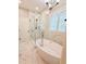 Bathroom featuring soaking tub, walk-in glass shower and bright lighting at 3871 Portland Trail Dr, Suwanee, GA 30024