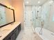 Luxurious bathroom featuring dual vanities, a soaking tub, and glass-enclosed shower at 3871 Portland Trail Dr, Suwanee, GA 30024