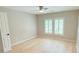 Spacious bedroom featuring hardwood floors and plantation shutters at 3871 Portland Trail Dr, Suwanee, GA 30024
