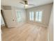 Bright bedroom with light hardwood floors, closet, and plantation shutters, creating a cozy retreat at 3871 Portland Trail Dr, Suwanee, GA 30024