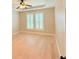 Bright bedroom with hardwood floors, a ceiling fan, and plantation shutters at 3871 Portland Trail Dr, Suwanee, GA 30024