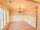 Bright dining room with hardwood floors, wainscotting, plantation shutters and chandelier at 3871 Portland Trail Dr, Suwanee, GA 30024