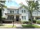 Charming two-story home with a welcoming front porch, lush landscaping, and classic architectural details at 3871 Portland Trail Dr, Suwanee, GA 30024