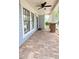 View of the front porch with brick flooring, white columns, and black trimmed windows at 3871 Portland Trail Dr, Suwanee, GA 30024