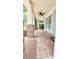 Covered front porch with brick flooring and white columns at 3871 Portland Trail Dr, Suwanee, GA 30024
