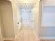 Hallway with light hardwood floors and neutral paint at 3871 Portland Trail Dr, Suwanee, GA 30024