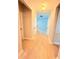 Inviting hallway featuring hardwood floors and neutral paint, leading to open living spaces at 3871 Portland Trail Dr, Suwanee, GA 30024