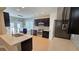 Modern kitchen with an island, stainless steel appliances, and sleek dark cabinets at 3871 Portland Trail Dr, Suwanee, GA 30024