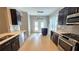 Modern kitchen boasts dark cabinets, stainless steel appliances, and a center island at 3871 Portland Trail Dr, Suwanee, GA 30024