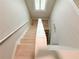 Well-lit staircase with light hardwood steps and white risers, leading to the upper level at 3871 Portland Trail Dr, Suwanee, GA 30024