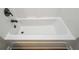 Close-up of a white bathtub with a black faucet and fixtures at 6005 Crowley Dr, Douglasville, GA 30135