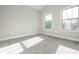 Bright bedroom with plush carpet, neutral walls and two windows at 6005 Crowley Dr, Douglasville, GA 30135