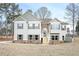 Charming two-story home featuring a stone archway, gray siding and a well-manicured lawn at 6005 Crowley Dr, Douglasville, GA 30135