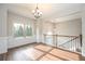 Bright foyer features gleaming hardwood floors, wainscotting and a staircase with wooden handrail at 6005 Crowley Dr, Douglasville, GA 30135
