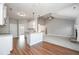 Open kitchen with white cabinets, center island with stone countertop and hardwood floors at 6005 Crowley Dr, Douglasville, GA 30135