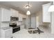 Modern kitchen featuring granite countertops, white cabinets, stainless steel appliances, and a subway tile backsplash at 6005 Crowley Dr, Douglasville, GA 30135