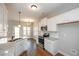 Kitchen features white cabinets, granite countertops, stainless appliances, hardwood floors, and access to the dining area at 6005 Crowley Dr, Douglasville, GA 30135
