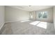 Spacious living room illuminated by natural light with plush neutral carpet at 6005 Crowley Dr, Douglasville, GA 30135
