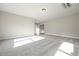 Large living room with neutral carpet and walls, complemented by natural lighting at 6005 Crowley Dr, Douglasville, GA 30135