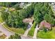 Aerial view of a home with a long driveway surrounded by mature trees on a well manicured lot at 625 Chaseridge Dr, Mcdonough, GA 30253