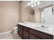 Bathroom with double vanity sinks, large mirror, and neutral color palette at 625 Chaseridge Dr, Mcdonough, GA 30253